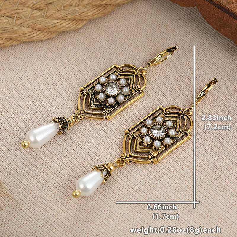 Vintage goldene Ohrringe mit eingelegter Perle