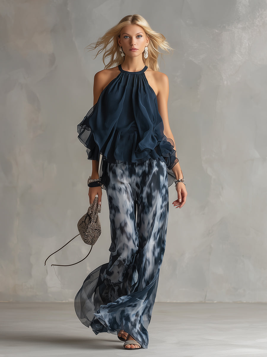 Luisa - Elegante chiffonjurk met een hooggesloten top en een wijde broek met patroon.