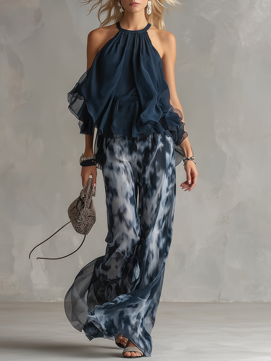 Luisa - Elegante chiffonjurk met een hooggesloten top en een wijde broek met patroon.
