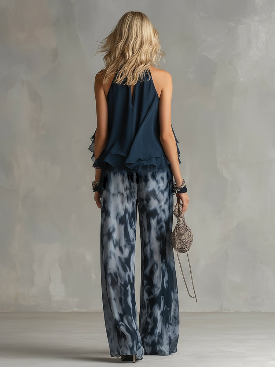 Luisa - Elegante chiffonjurk met een hooggesloten top en een wijde broek met patroon.